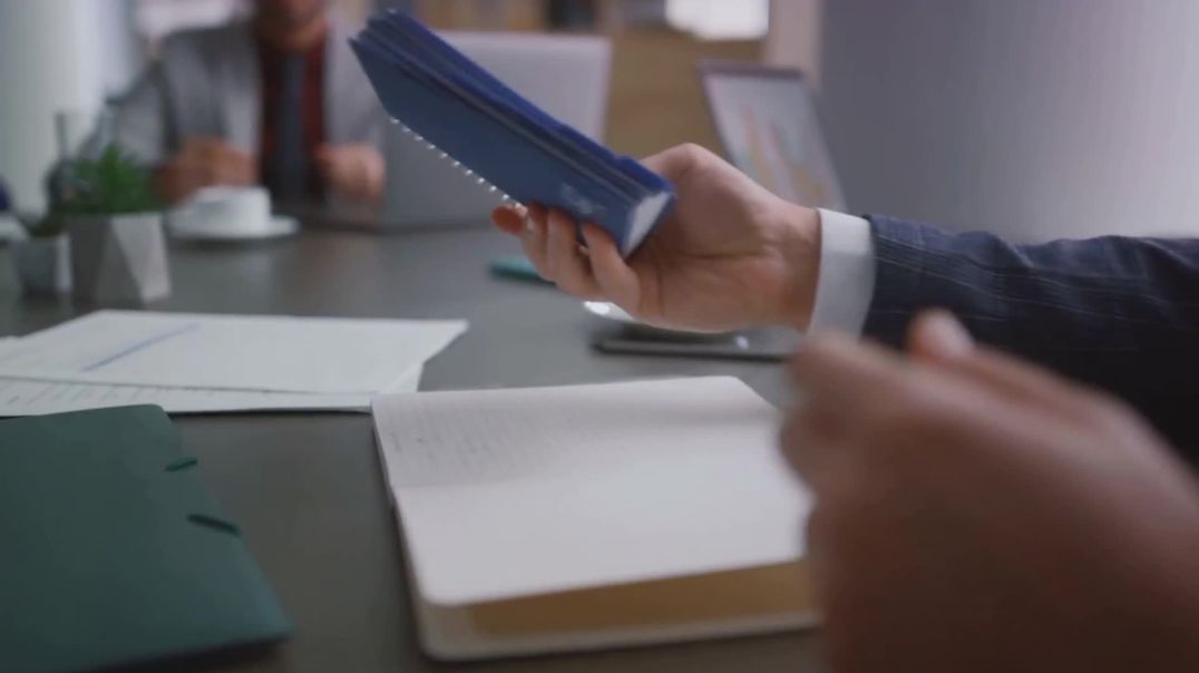 ⁣Business Professional Handling Blue Notebook Free Stock Footage