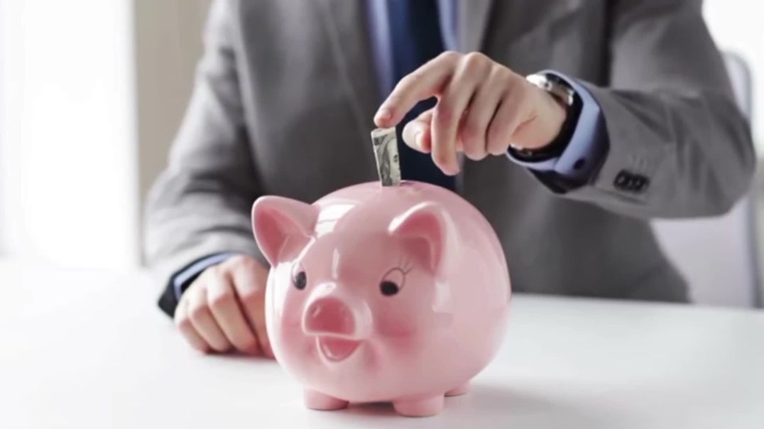 ⁣Man Putting Dollar into Pink Piggy Bank Free Stock Footage