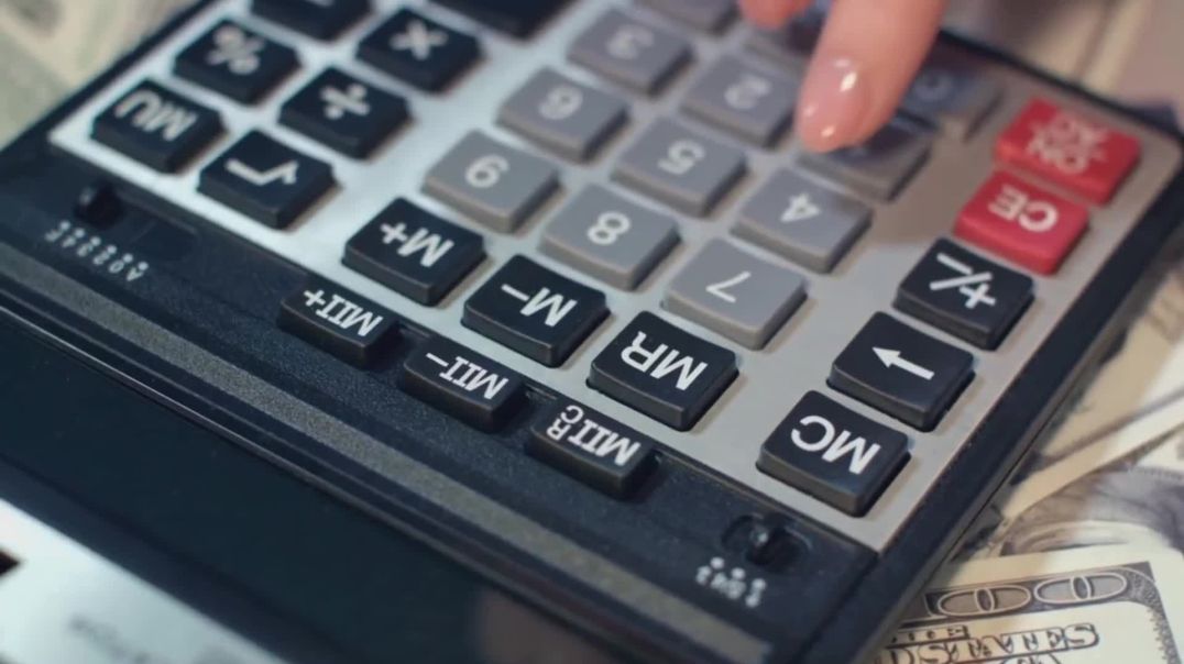 ⁣Close-up of Hand Using Calculator Over Cash Free Stock Footage