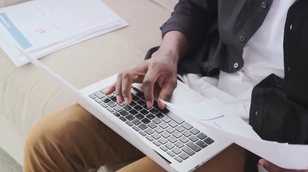⁣Man Working on Laptop with Documents Free Stock Footage
