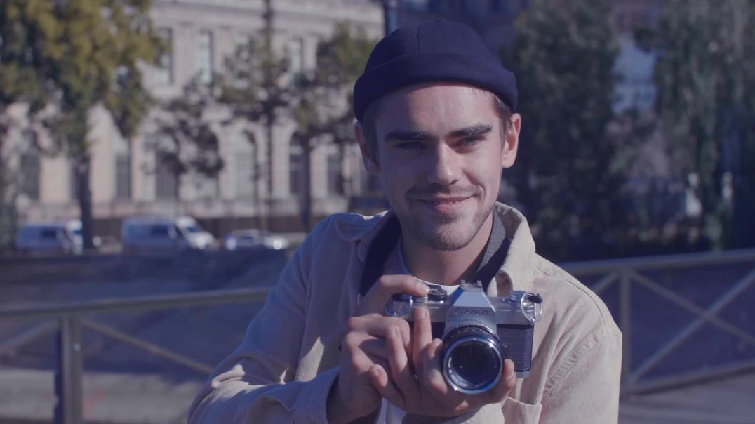 ⁣Young Photographer Smiling with Retro Camera Free Footage