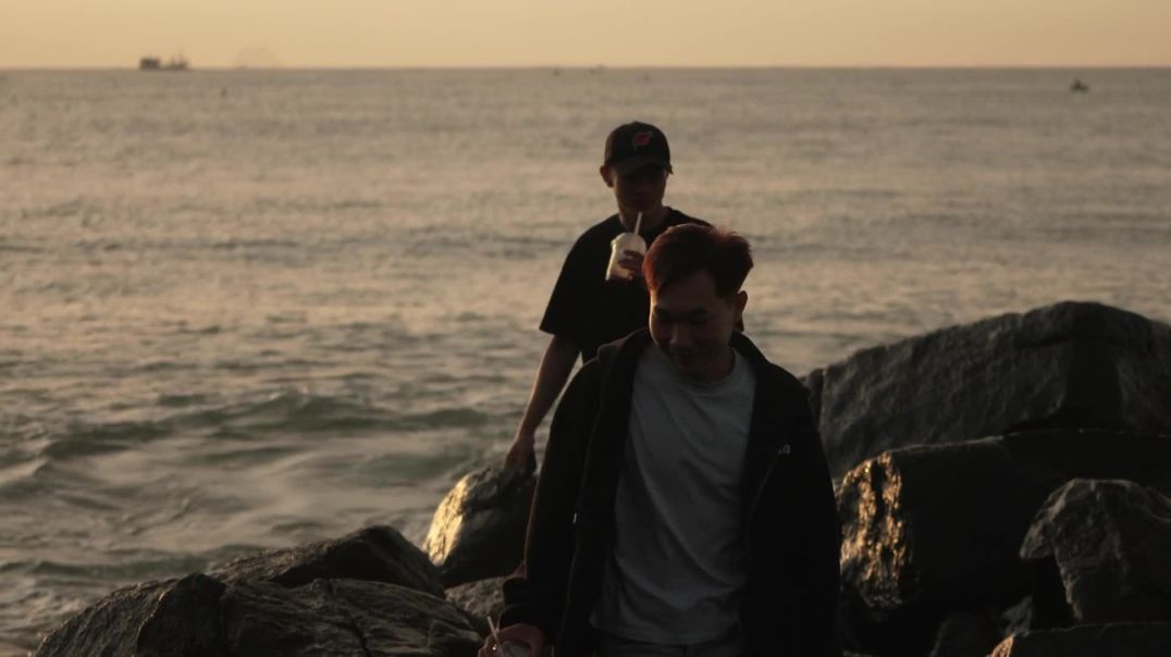 ⁣Cinematic Coastal Sunset Men on Rocks Free Stock Footage
